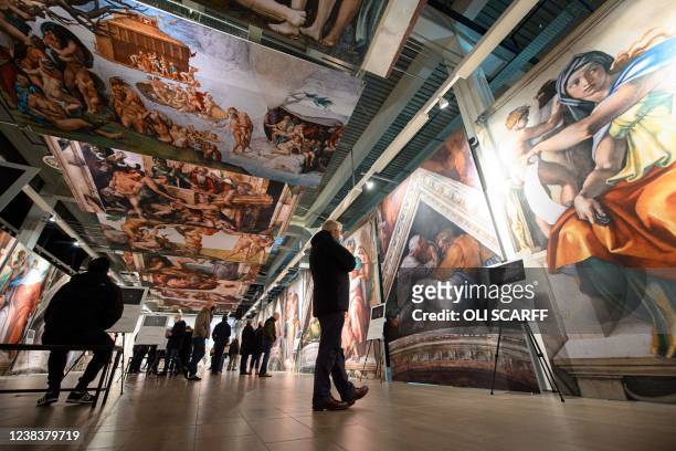 Members of the public attend the exhibition 'Michelangelo's Sistine Chapel' at Trafford Palazzo in Manchester, north-west England on February 11,...
