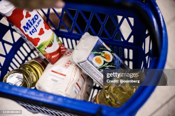 Basket containing 2.8% milk, sunflower oil and flour, all subject to a government price cap, inside a grocery store in Budapest, Hungary, on Friday,...