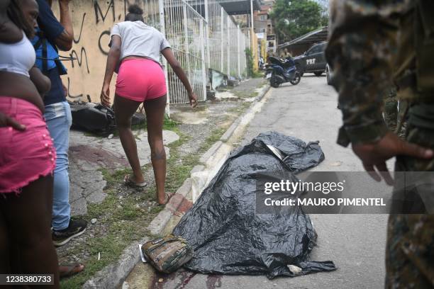 Graphic content / A body lies on a street after a police raid in the neighborhood of Vila Cruzeiro, on Rio de Janeiro's north side, Brazil, on...