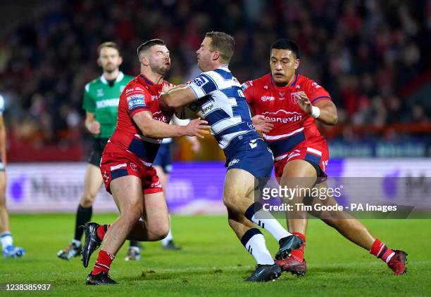 Wigan Warriors' Iain Thornley is tackled by Hull KR's Matthew Storton and Albert Vete during the Betfred Super League match at the Sewell Group...