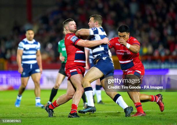 Wigan Warriors' Iain Thornley is tackled by Hull KR's Matthew Storton and Albert Vete during the Betfred Super League match at the Sewell Group...