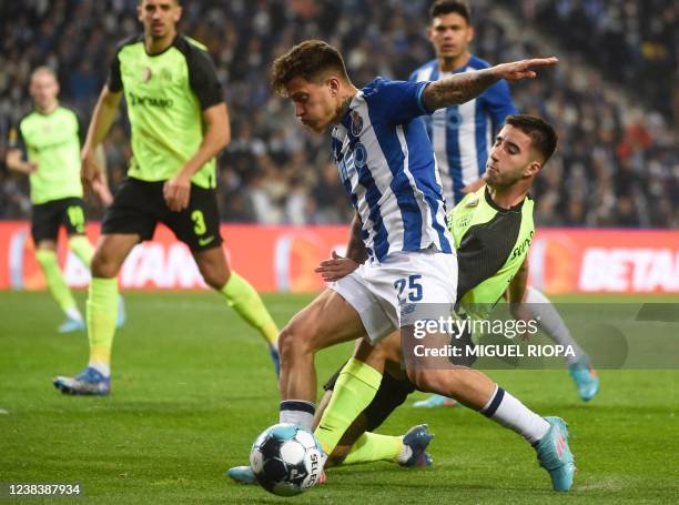 Porto's Brazilian midfielder Otavio da Silva fights for the ball with Sporting Lisbon's Portuguese defender Goncalo Inacio during the Portuguese...