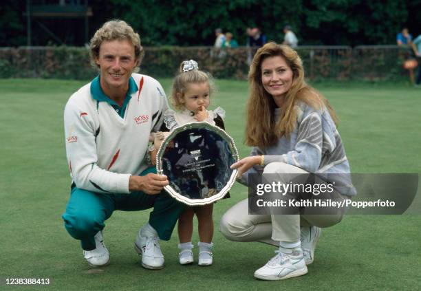 Bernhard Langer of West Germany celebrates with the trophy alongside his wife Vikki and their daughter Jackie after winning the final against Mark...