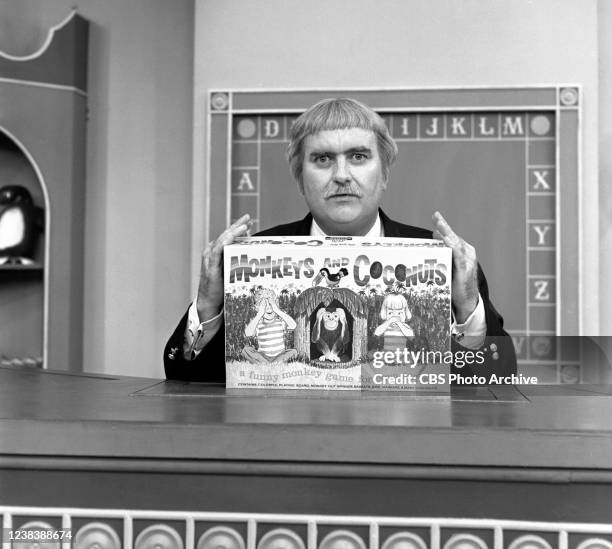 Pictured is Bob Keeshan as Captain Kangaroo holding a game titled, 'Monkeys and Coconuts,' on CAPTIAN KANGAROO, a CBS television children's show....