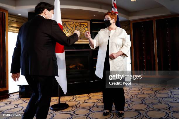 Japanese Minister for Foreign Affairs Hayashi Yoshimasa and Australian Minister for Foreign Affairs Marise Payne fist bump during a meeting of the...