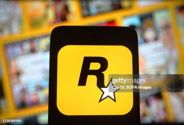 In this photo illustration, a Rockstar Games Inc logo of a video game publisher is seen on a smartphone screen.