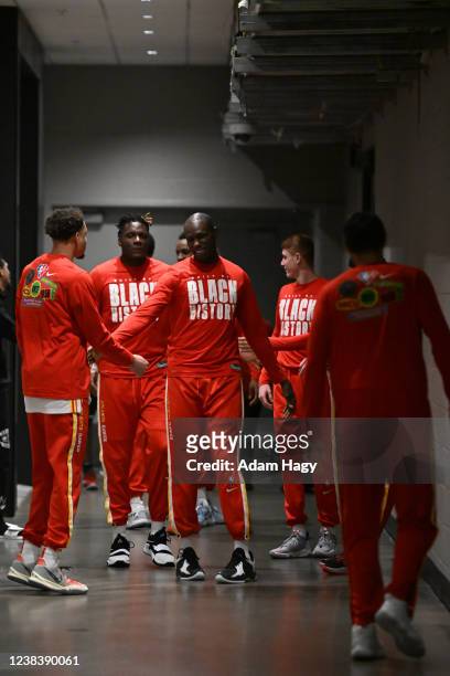 Gorgui Dieng of the Atlanta Hawks high fives his teammates before the game against the San Antonio Spurs on February 11, 2022 at State Farm Arena in...