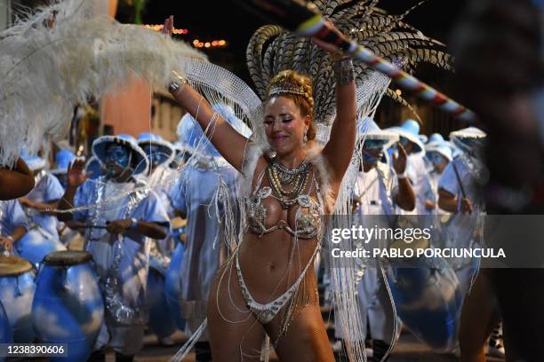 Dancer and drummers forming part of a group known as a "comparsa" compete by playing and dancing to the rhythm of the traditional "candombe" music,...
