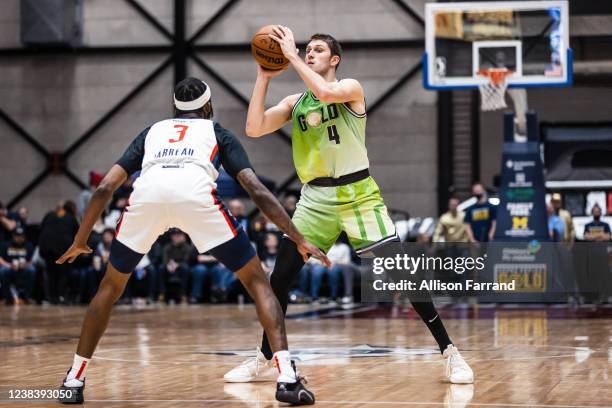 Matt Ryan of the Grand Rapids Gold looks to pass against Dejon Jarreau of the Capital City Go-Go on February 11, 2022 at DeltaPlex Arena in Grand...