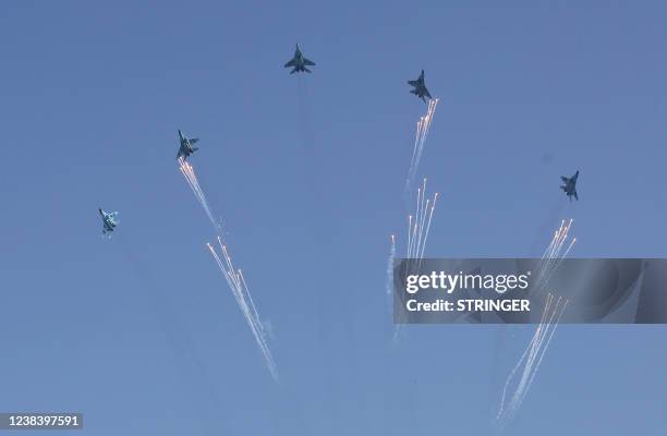 Myanmar junta fighter jets perform during a ceremony to mark the 75th anniversary of the country's Union Day in Naypyidaw on February 12, 2022.