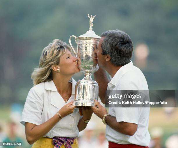 Curtis Strange of the United States and his wife Sarah celebrate with the trophy after winning the US Open Golf Championship at The Country Club on...