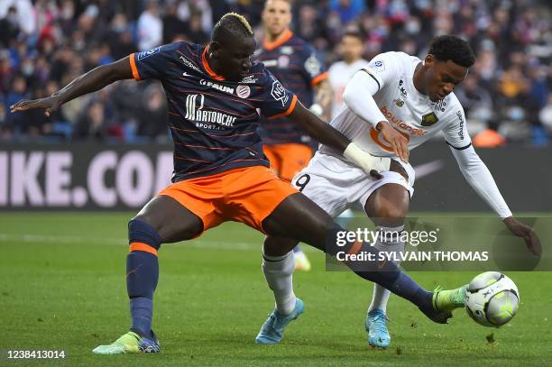 Lille's Canadian forward Jonathan David challenges Montpellier's French defender Mamadou Sakho during the French L1 football match Montpellier vs...