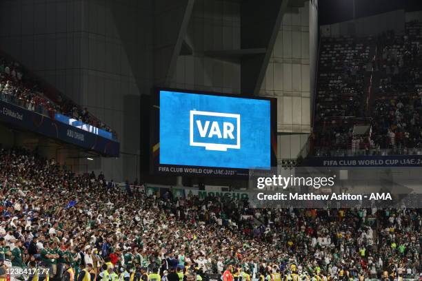 The VAR logo is seen on a giant LED board informing the fans that a decision in process during the FIFA Club World Cup UAE 2021 Final match between...