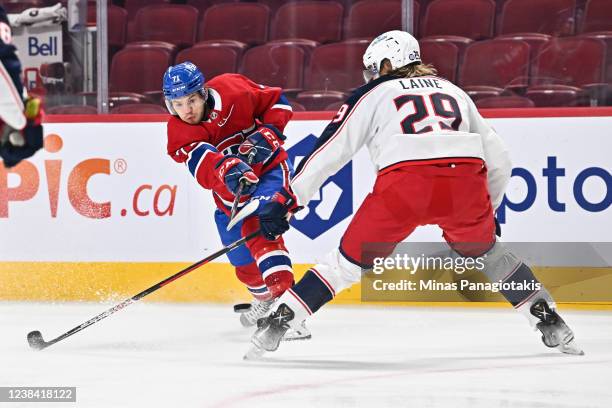 Jake Evans of the Montreal Canadiens shoots the puck past Patrik Laine of the Columbus Blue Jackets during the second period at Centre Bell on...