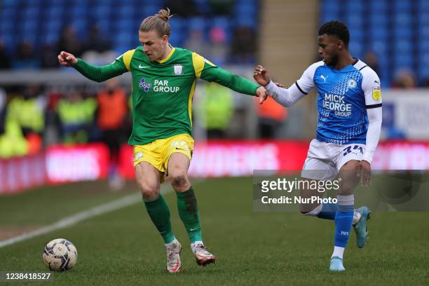 Brad Potts of Preston North End runs with the ball under pressure from Bali Mumba of Peterborough United during the Sky Bet Championship match...