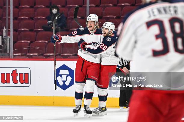 Patrik Laine of the Columbus Blue Jackets celebrates his power play goal with teammate Oliver Bjorkstrand during the third period against the...