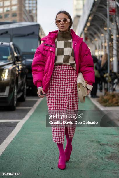 Sasha Barno wears a by Lenki Lenki, sweater by W.Awake, skirt and shoes by Zara, handbag by Strasthberry and earrings by Prada to NYFW at Spring...