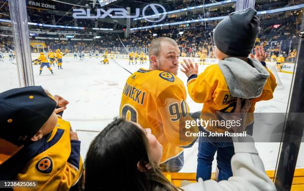 Mark Borowiecki of the Nashville Predators says hello to his son during warmups prior to an NHL game against the Winnipeg Jets at Bridgestone Arena...