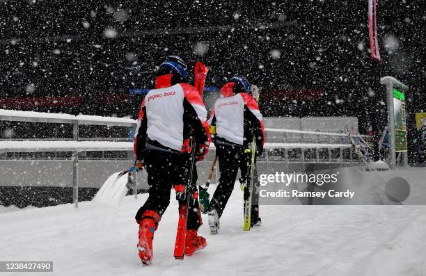 Yanqing , China - 13 February 2022; Course workers make their way to the gondola before the Men's Giant Slalom event on day nine of the Beijing 2022...