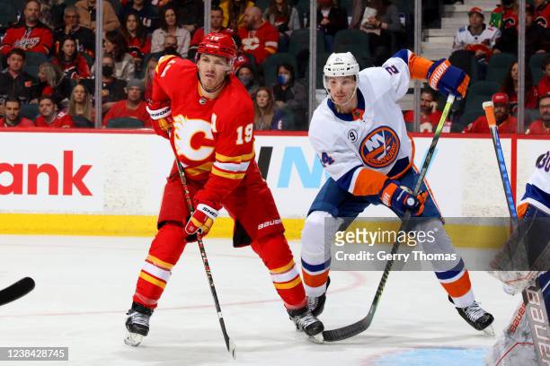 Matthew Tkachuk of the Calgary Flames skates against Scott Mayfield of the New York Islanders at Scotiabank Saddledome on February 12, 2022 in...