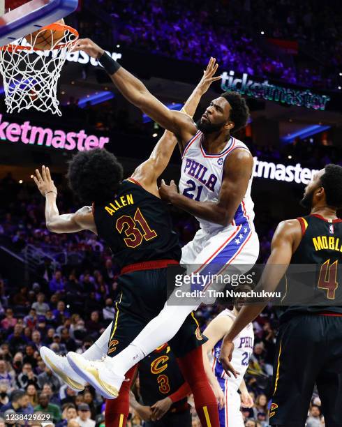 Joel Embiid of the Philadelphia 76ers dunks over Jarrett Allen of the Cleveland Cavaliers during the second quarter at Wells Fargo Center on February...