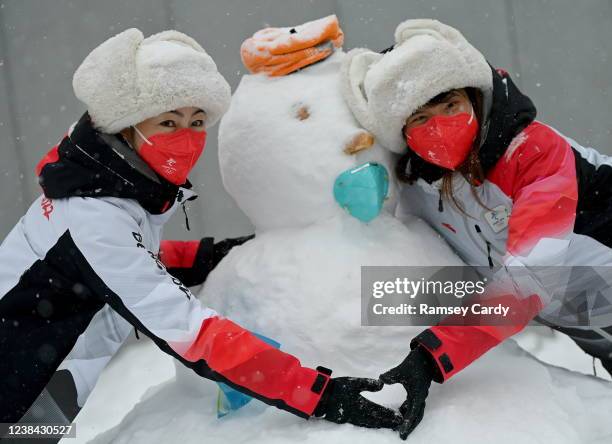 Yanqing , China - 13 February 2022; Volunteers with a snowman during a break in the Men's Giant Slalom event on day nine of the Beijing 2022 Winter...