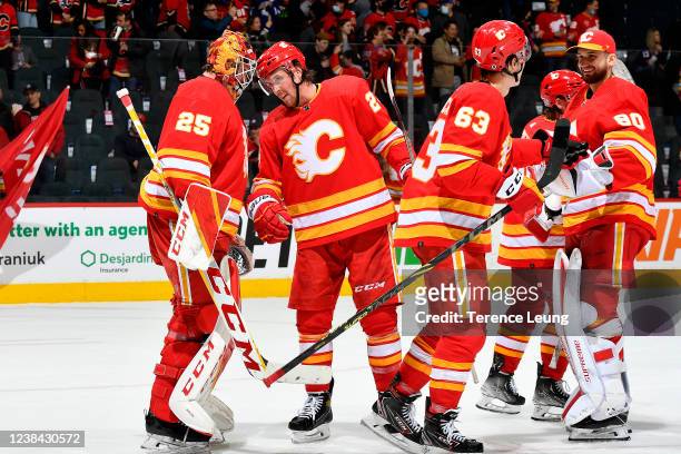 Jacob Markstrom and teammates of the Calgary Flames celebrate a win against the New York Islanders at Scotiabank Saddledome on February 12, 2022 in...