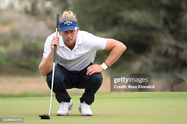 Marcel Siem of Germany lines up a putt on the 1st hole during day four of the Ras Al Khaimah Classic at Al Hamra Golf Club on February 13, 2022 in...