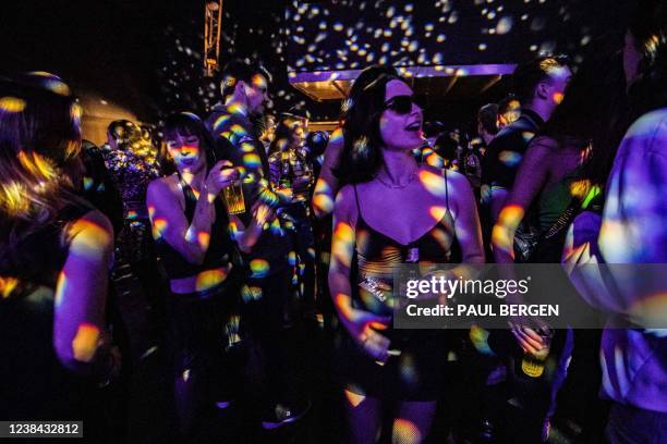 Partygoers dance at The Helling , in Amsterdam on February 12 as they take part to a protest action so called "The Night Stands protest" to draw...