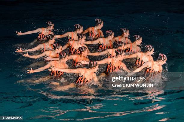 Performers take part in a demonstration of synchronized swimming to celebrate the 80th birthday of late North Korean leader Kim Jong Il, known as the...