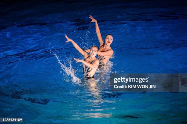 Performers take part in a demonstration of synchronized swimming to celebrate the 80th birthday of late North Korean leader Kim Jong Il, known as the...