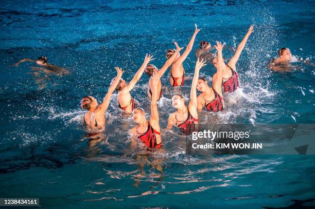 Performers take part in a demonstration of synchronized swimming to celebrate the 80th birthday of late North Korean leader Kim Jong Il, known as the...