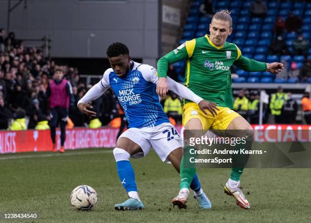 Preston North End's Brad Potts competing with Peterborough United's Bali Mumba during the Sky Bet Championship match between Peterborough United and...