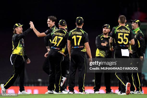 Australia's Pat Cummins celebrates the wicket of Sri Lanka's batsman Charith Asalanka with teammates during the second T20 international cricket...