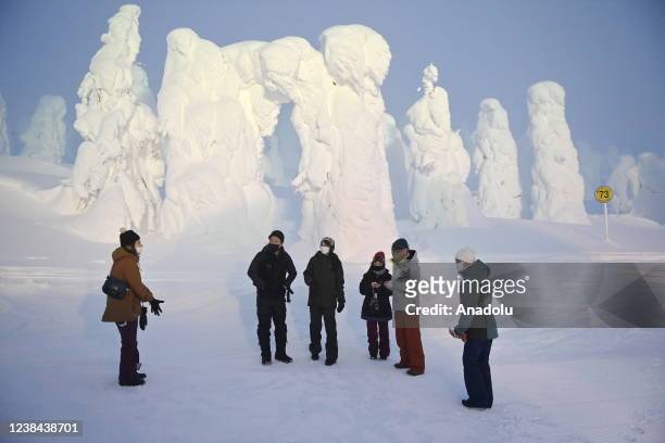 People are seen close to Frost-covered conifers, called Snow Monsters, Juhyo in Japanese, which decorate the snowy landscape of Mount Zao on Feb. 8...