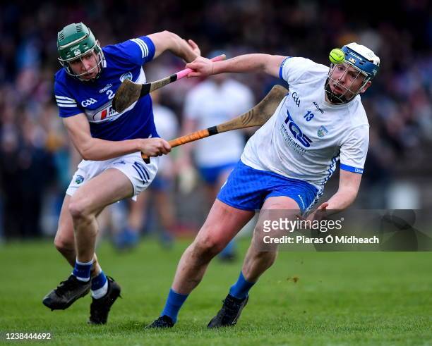 Waterford , Ireland - 13 February 2022; Stephen Bennett of Waterford in action against Diarmuid Conway of Laois during the Allianz Hurling League...