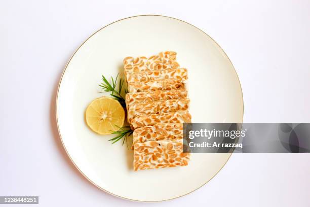 tempeh slices on a white background - tempe stock pictures, royalty-free photos & images