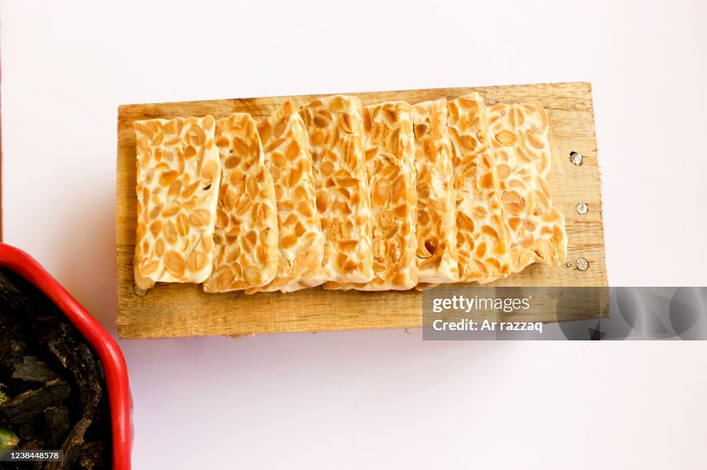 Close-up tempe on rustic wood with a white background