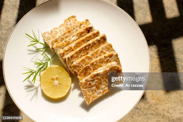 close-up of raw tempe slices - tempe stock pictures, royalty-free photos & images