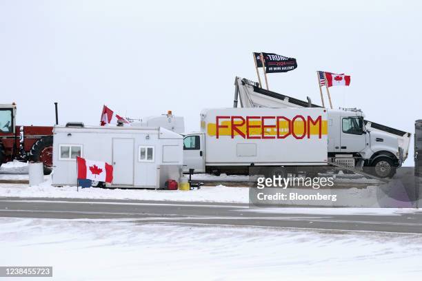 Trucks and tractors blockade the U.S.-Canada border crossing during a demonstration in Emerson, Manitoba, Canada, on Sunday, Feb. 13, 2022....
