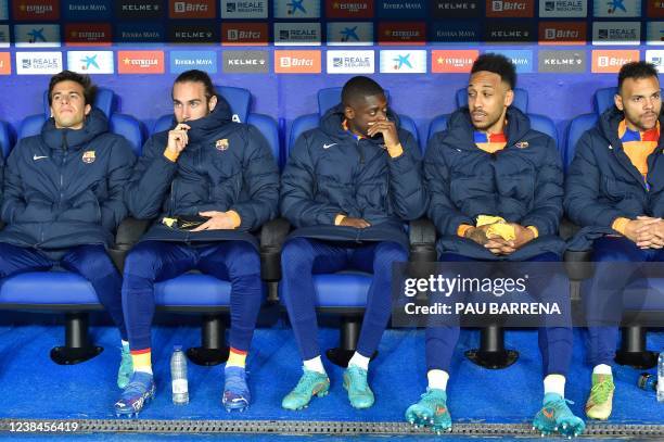 Barcelona's French forward Ousmane Dembele and Barcelona's Gabonese midfielder Pierre-Emerick Aubameyang talk on the bench, during the Spanish league...