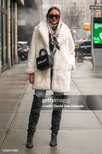 Kate Vaseha wears a faux fur coat by Apparis, pants by Zara, top by H&M, handbag by Michino and boots by AGL to New York Fashion Week at Spring...