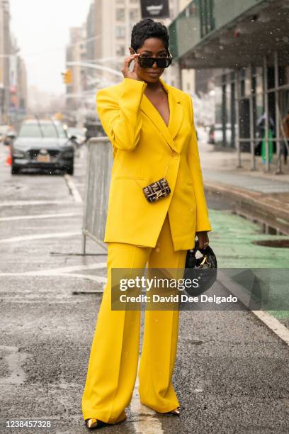 Jenner Naylor wears a suit and shoes by Zara, mini handbag by Fendi, handbag by Bitters to New York Fashion Week at Spring Studios on February 13,...