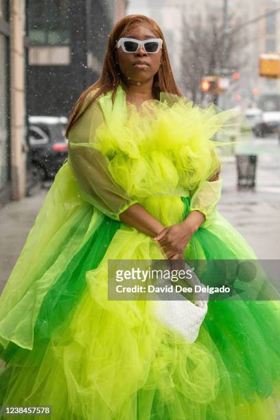 Melody Asherman wears a dress of her own design, shoes by Shoe Dazzle and handbag by Mleada & Kou to New York Fashion Week at Spring Studios on...