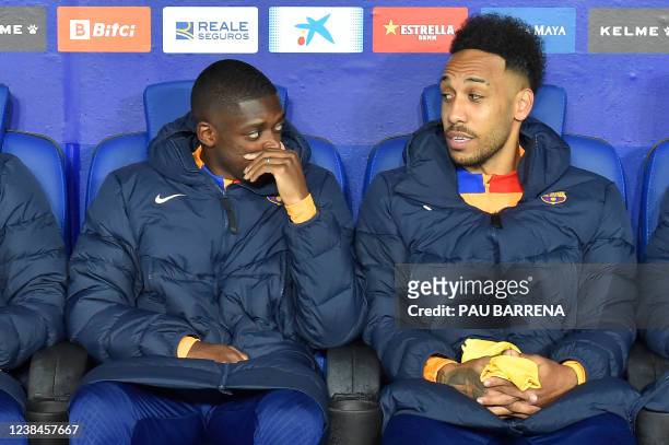 Barcelona's French forward Ousmane Dembele and Barcelona's Gabonese midfielder Pierre-Emerick Aubameyang talk on the bench, during the Spanish league...