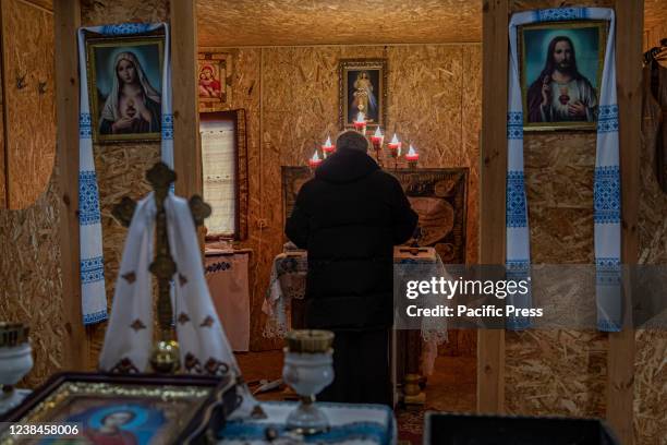 Military Chaplin prays inside the soldier-built chapel at the 66th mobile military hospital in Pokrovsk, Ukraine, about 25 miles from the Eastern...