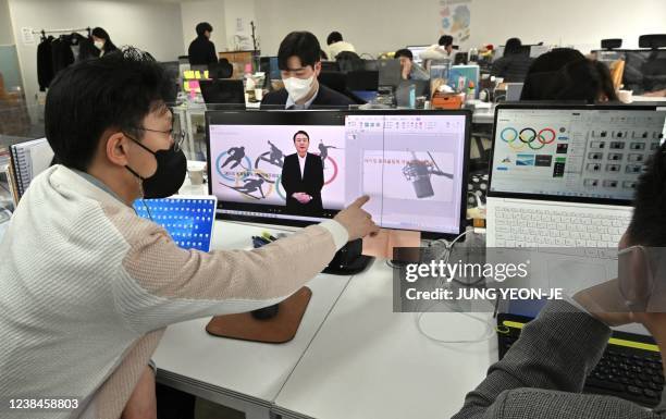 This picture taken on February 7, 2022 shows Baik Kyeong-hoon , director of the "AI Yoon" team, making a video clip using "AI Yoon", a digital avatar...