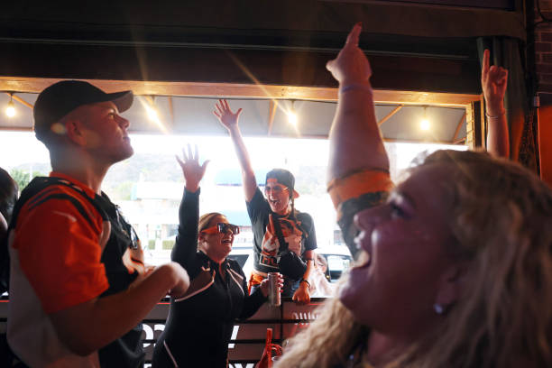 Ethan Quick, Desiree Maynard, Steph DArrigo and Julie Marshall, from left, celebrate the Bengals' score during a Superbowl watch party at 5...