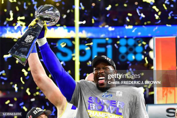 Los Angeles Rams' Von Miller holds up the trophy after winning Super Bowl LVI against the Cincinnati Bengals at SoFi Stadium in Inglewood,...