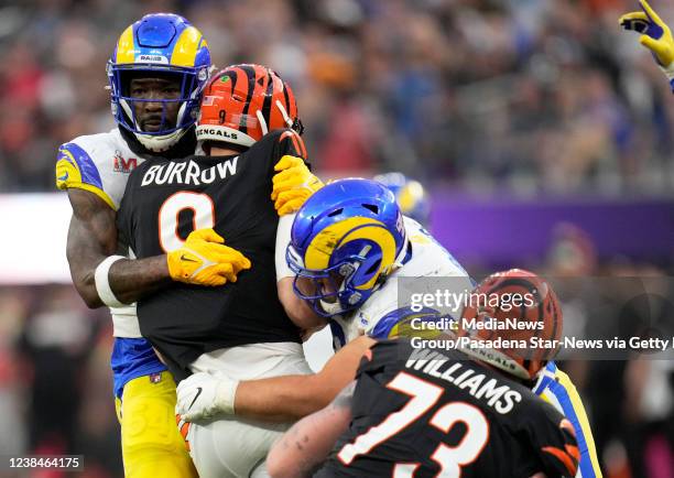 Inglewood, CA Quarterback Joe Burrow, second from left, of the Cincinnati Bengals gets sacked by outside linebacker Leonard Floyd, left, and nose...